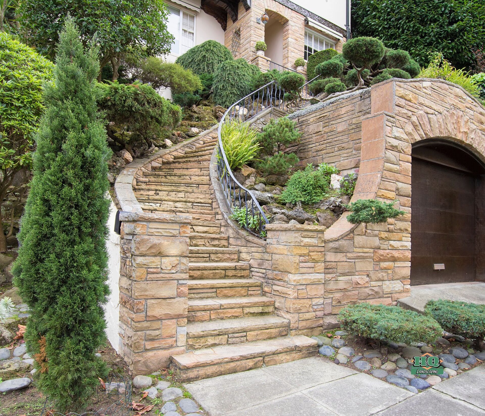 Stone veneer entry steps and wall installation on residential home in Southington CT by HQ Landscaping