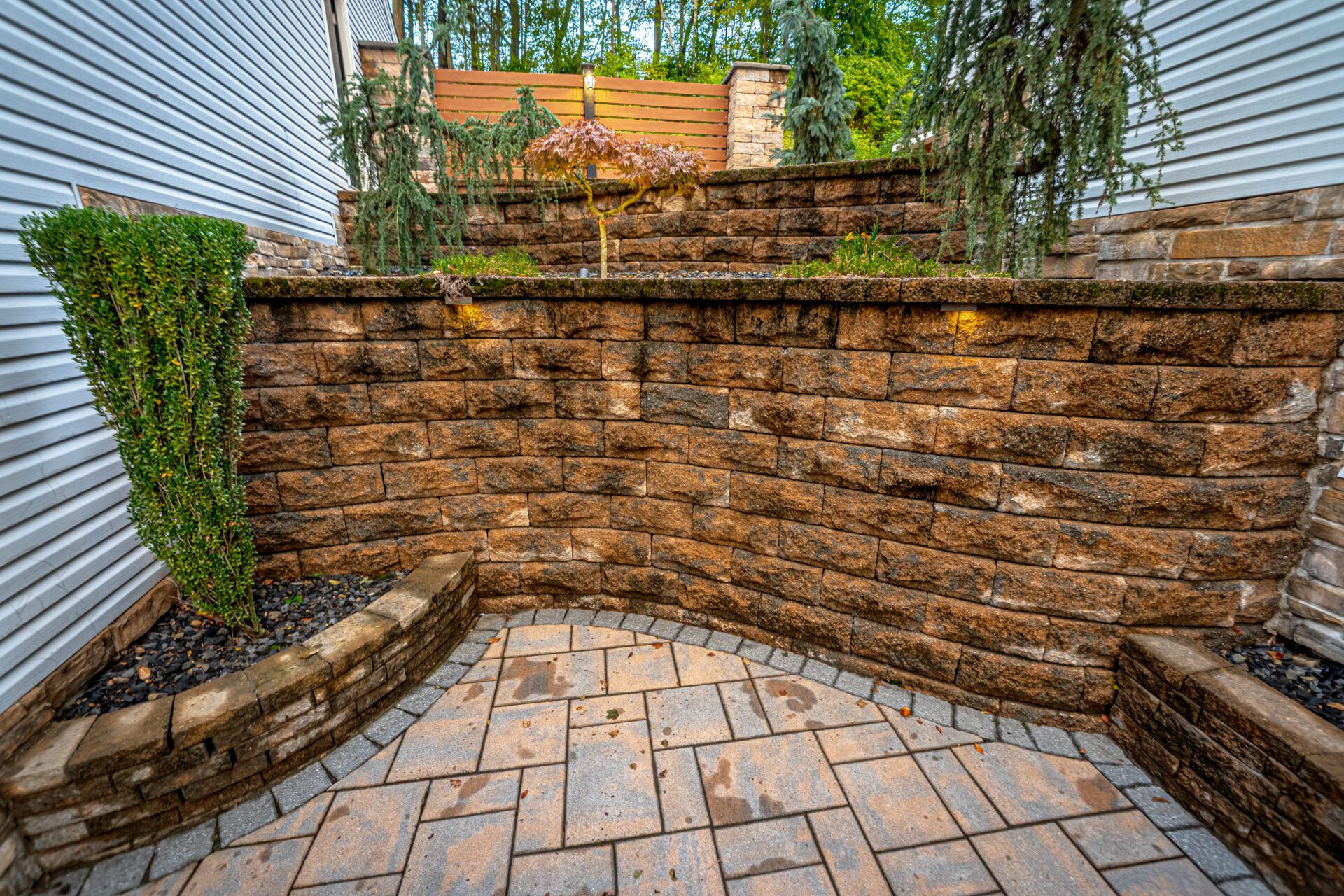 Stone retaining wall and paver hardscaping at a Southington CT home